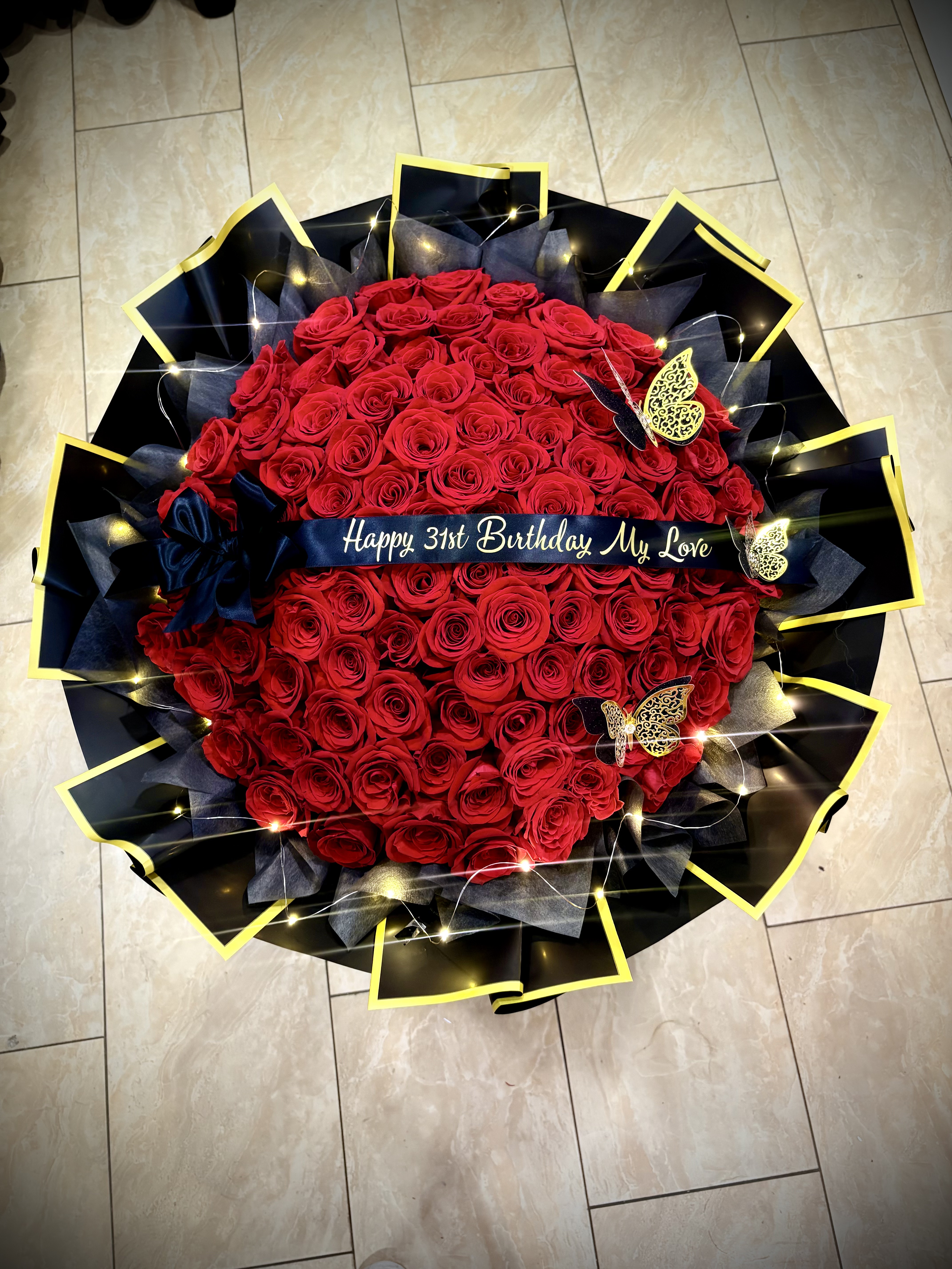 100 Rose Bouquet – Luxurious presentation of 100 premium Red Roses,a Custom Ribbon with Lights & Butterflies